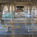 An elaborate network of scaffolding poles and platforms, a classic example of complex temporary works construction.