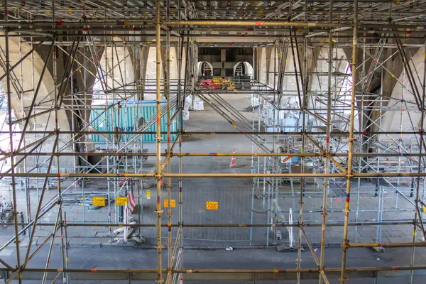 An elaborate network of scaffolding poles and platforms, a classic example of complex temporary works construction.