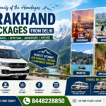 Promotional travel banner for Uttarakhand Tour Packages from Delhi featuring Himalayan mountains, an Urbania luxury vehicle, and famous destinations like Haridwar, Rishikesh, Mussoorie, Nainital, Jim Corbett, and Auli. The design highlights comfortable group travel, luxury tempo travellers, and contact number 8448228850.