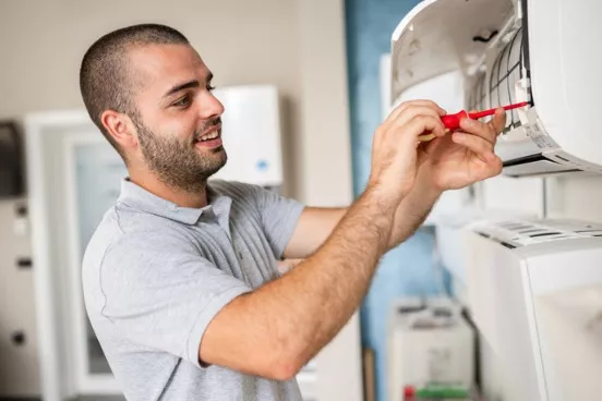 technician-cleaning-air-conditioner-filter