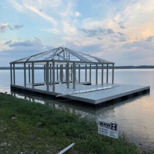 Metal dock frame under construction on a lakeside platform.