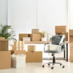 Cardboard boxes and packed chair in office. Moving day